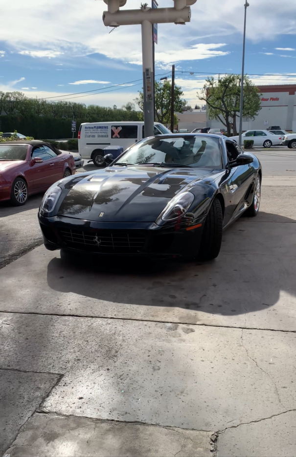 A black sports car parked in a parking lot